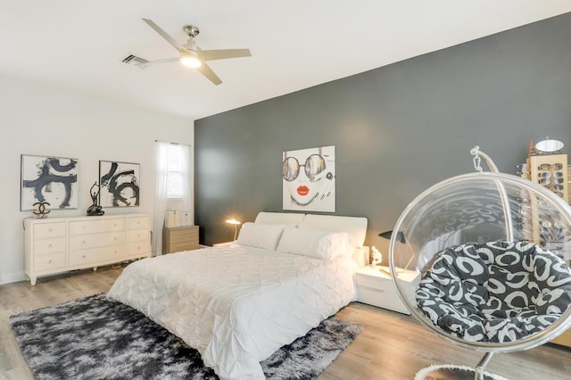 bedroom with ceiling fan and light hardwood / wood-style flooring