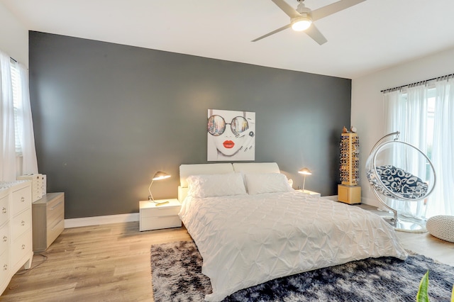 bedroom with ceiling fan and light wood-type flooring