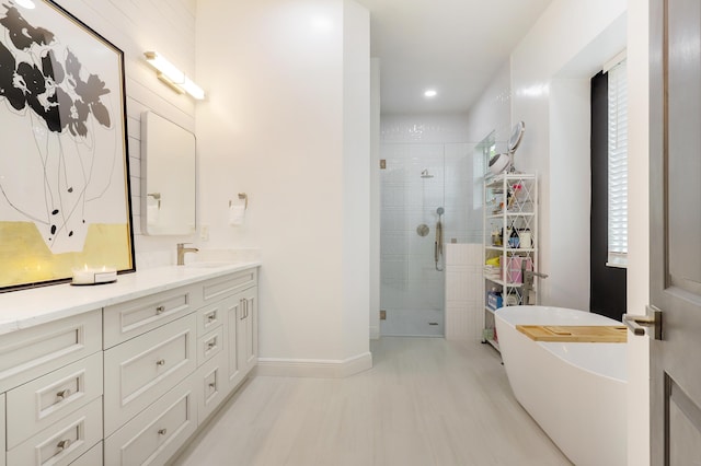 bathroom with independent shower and bath and vanity