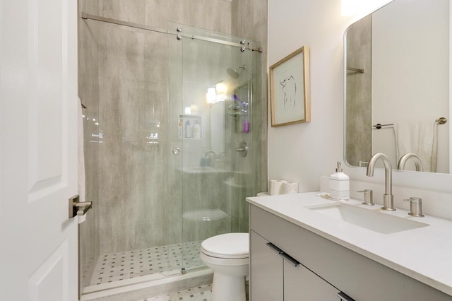 bathroom with an enclosed shower, vanity, and toilet