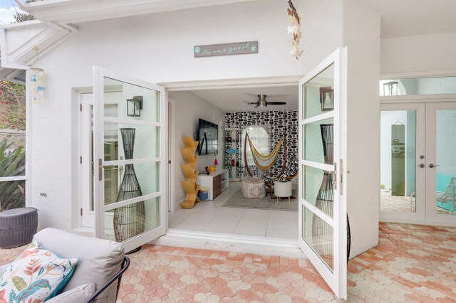 entrance to property featuring a patio area and ceiling fan