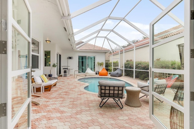 view of pool with a patio and glass enclosure