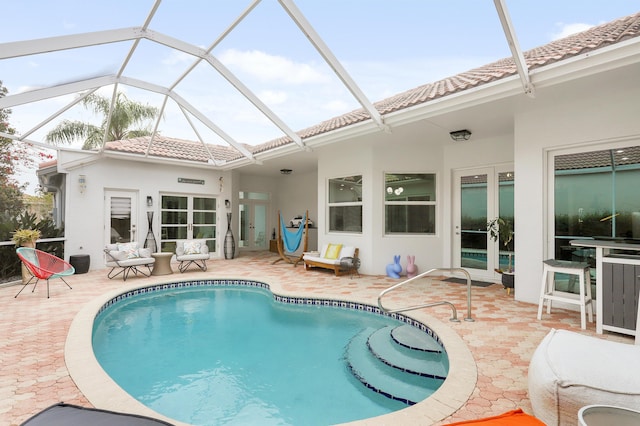 rear view of house featuring a lanai and a patio area