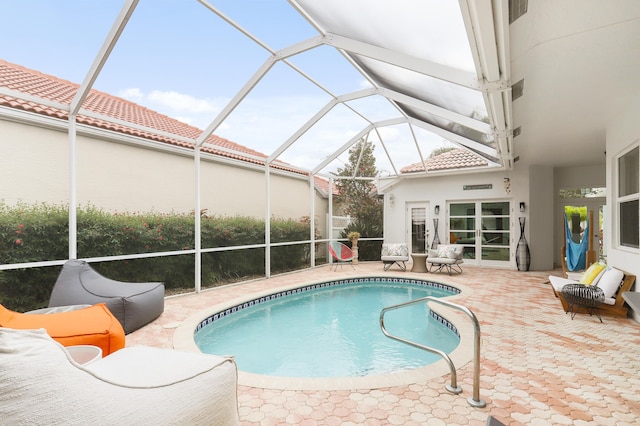 view of pool featuring a patio and glass enclosure