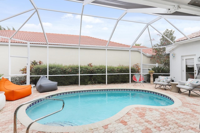 view of swimming pool with a lanai and a patio