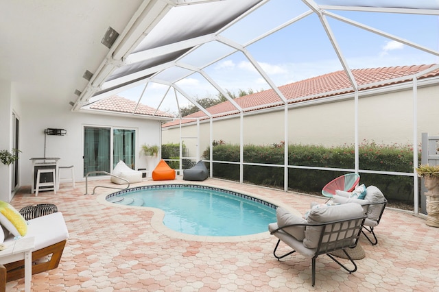 view of pool with a lanai and a patio