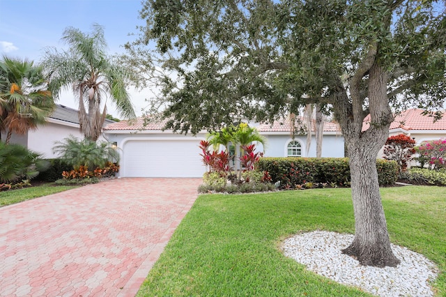 view of front of house with a garage and a front lawn