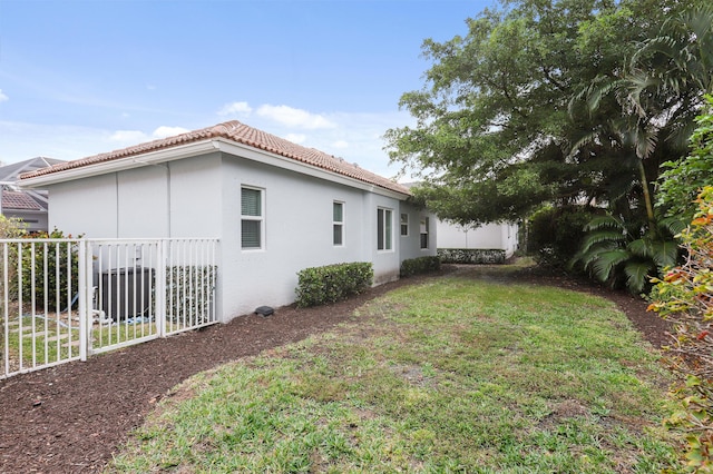 view of side of home featuring a yard