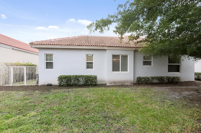 back of house with a lawn