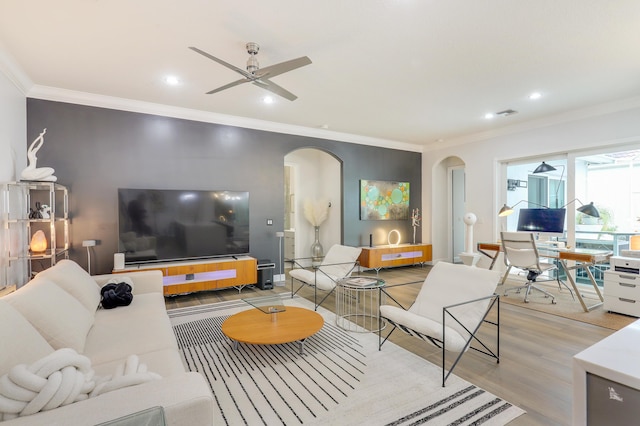 living room featuring ornamental molding, ceiling fan, and light hardwood / wood-style flooring