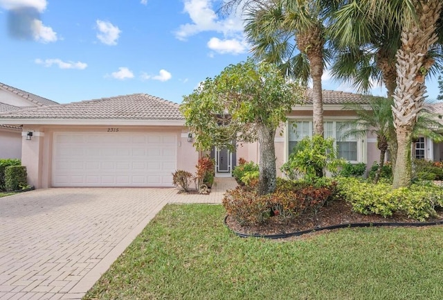 view of front of house with a garage and a front yard