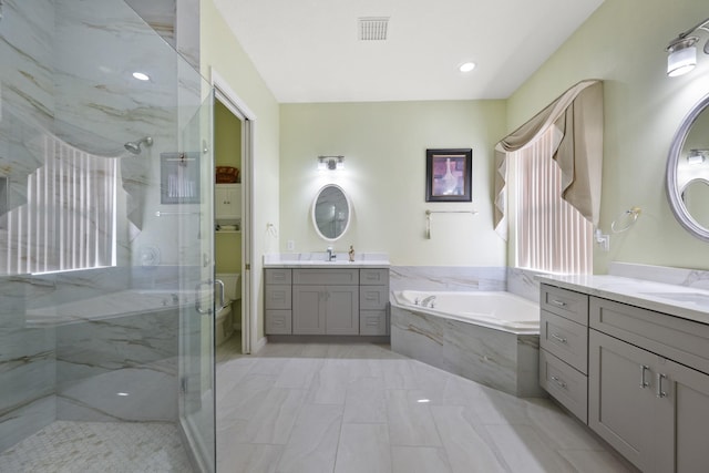 bathroom featuring vanity and plus walk in shower