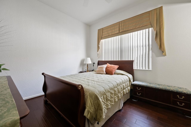 bedroom with ceiling fan and dark hardwood / wood-style floors