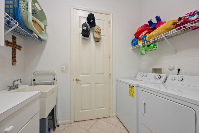 washroom with washing machine and clothes dryer and light tile patterned floors