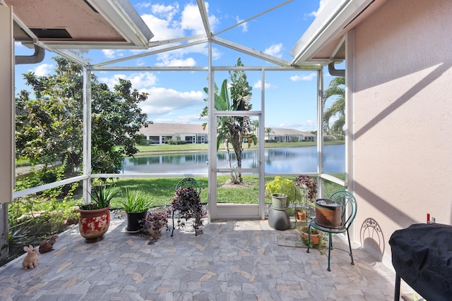 unfurnished sunroom featuring a water view