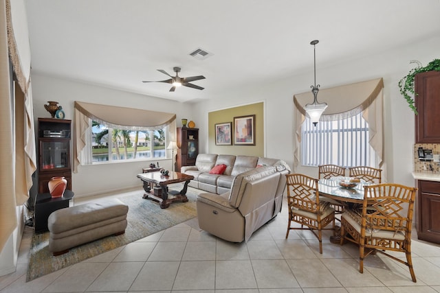 tiled living room featuring ceiling fan