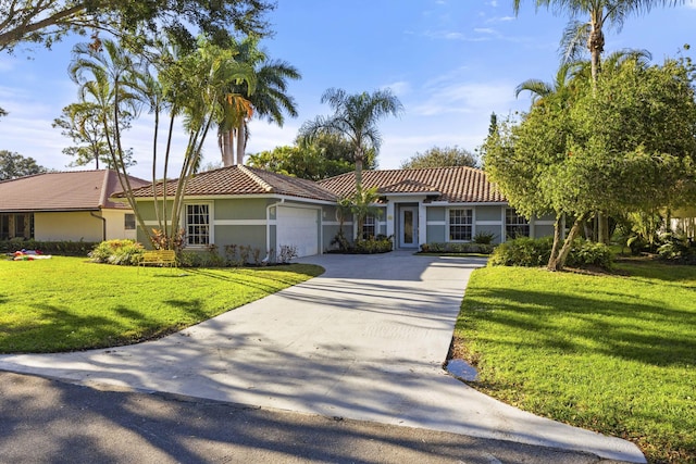 view of front of home with a front lawn and a garage