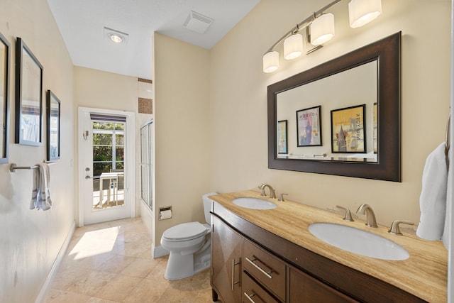 full bathroom featuring vanity, shower / bath combination with glass door, and toilet