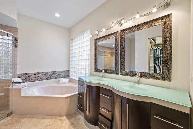 bathroom with tile patterned floors, vanity, and separate shower and tub