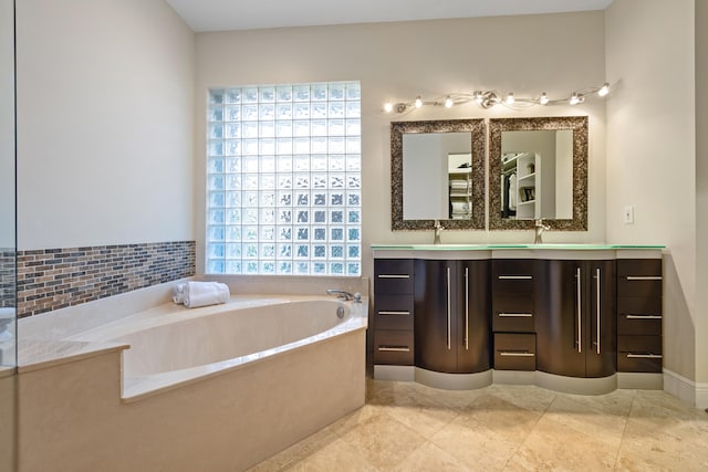 bathroom with vanity, a washtub, and tile patterned floors