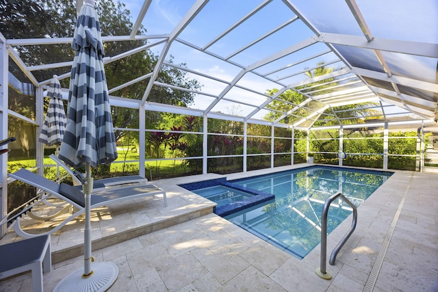 view of pool featuring an in ground hot tub, glass enclosure, and a patio area