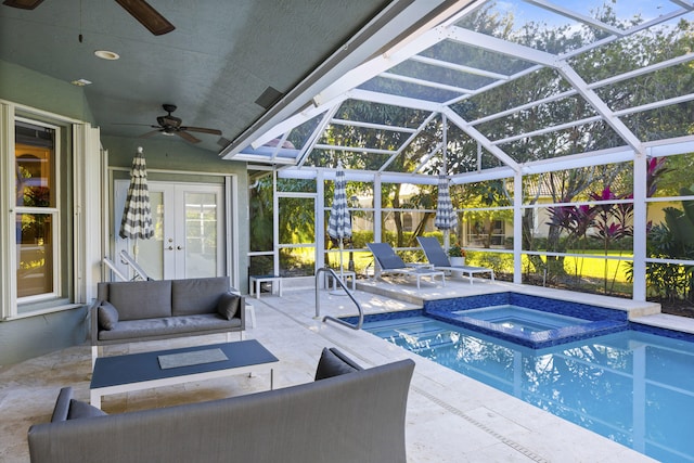 view of pool featuring an in ground hot tub, ceiling fan, a patio, and glass enclosure