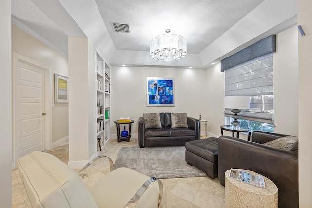 living room with an inviting chandelier, built in shelves, a raised ceiling, and a textured ceiling