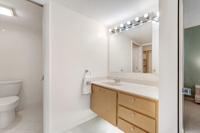 bathroom with vanity, toilet, and tile patterned flooring