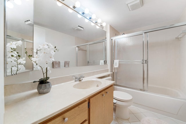 full bathroom featuring vanity, bath / shower combo with glass door, tile patterned floors, and toilet