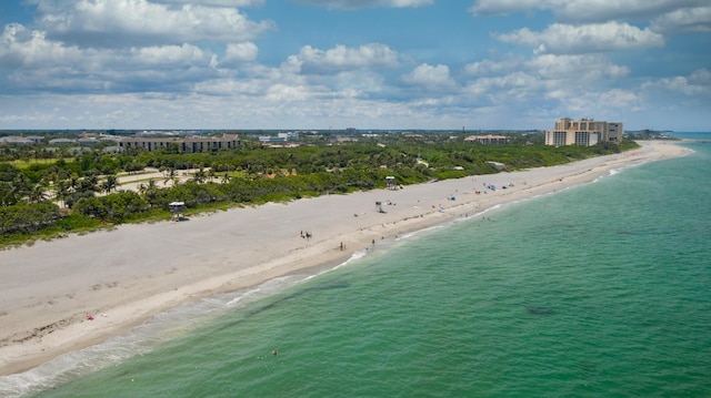 birds eye view of property featuring a beach view and a water view