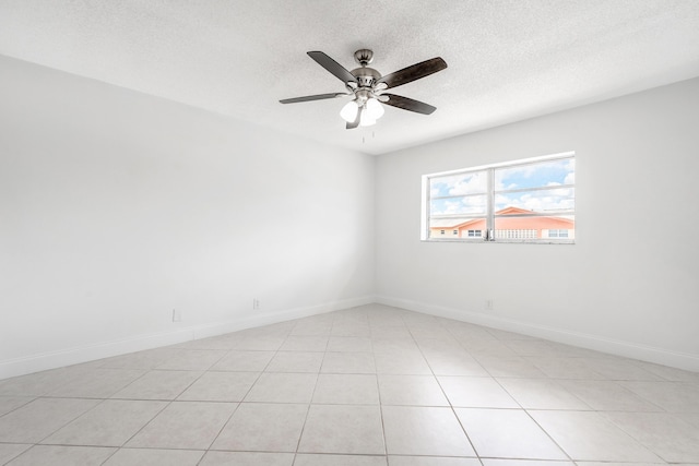 tiled empty room featuring ceiling fan