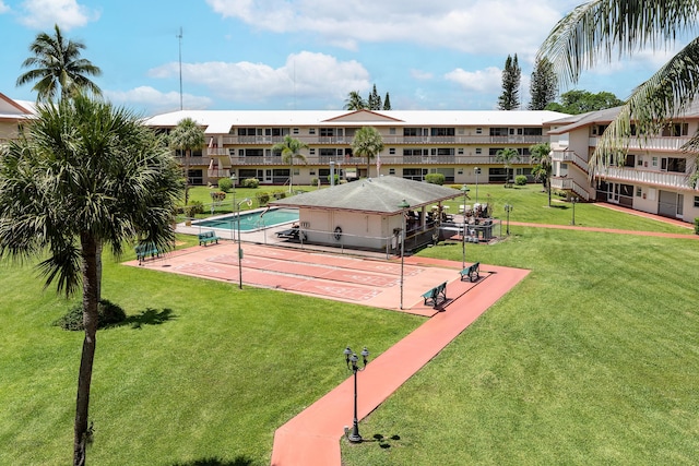 view of property's community with a lawn