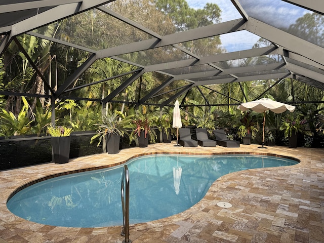 view of pool with a lanai and a patio