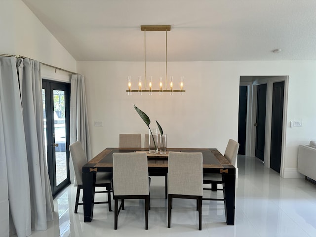 dining area featuring light tile patterned floors, vaulted ceiling, and a notable chandelier