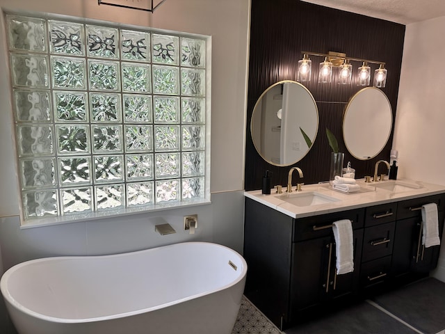 bathroom with a bathtub, tile patterned flooring, and vanity