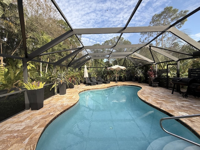 view of pool with a lanai, a patio, and area for grilling