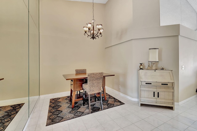 tiled dining area with a towering ceiling and a chandelier