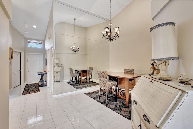 interior space featuring a high ceiling, light tile patterned floors, and an inviting chandelier