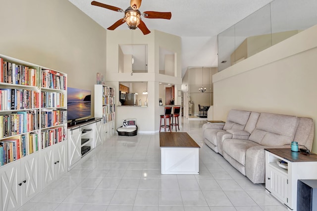 living room featuring ceiling fan, high vaulted ceiling, a textured ceiling, and light tile patterned floors