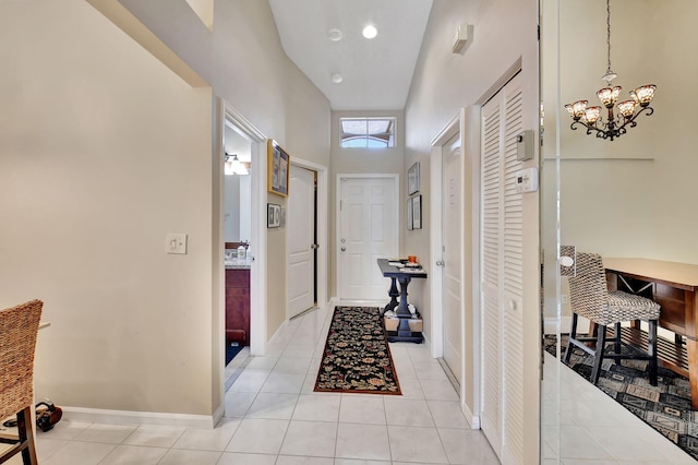 corridor with light tile patterned floors and a high ceiling