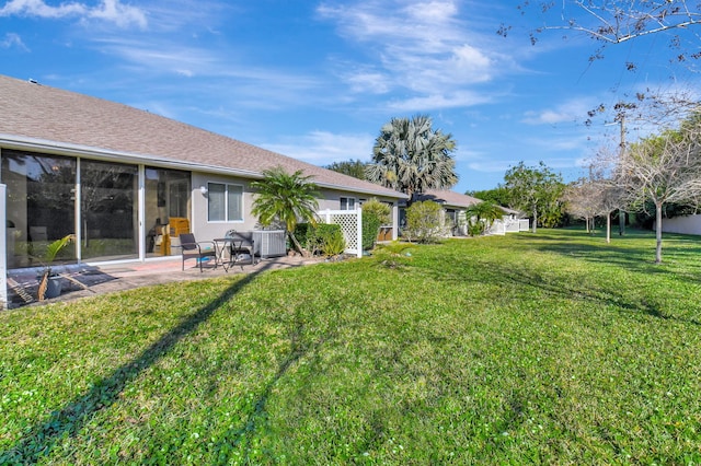 view of yard featuring central AC and a patio