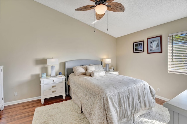 bedroom with hardwood / wood-style floors, a textured ceiling, and ceiling fan