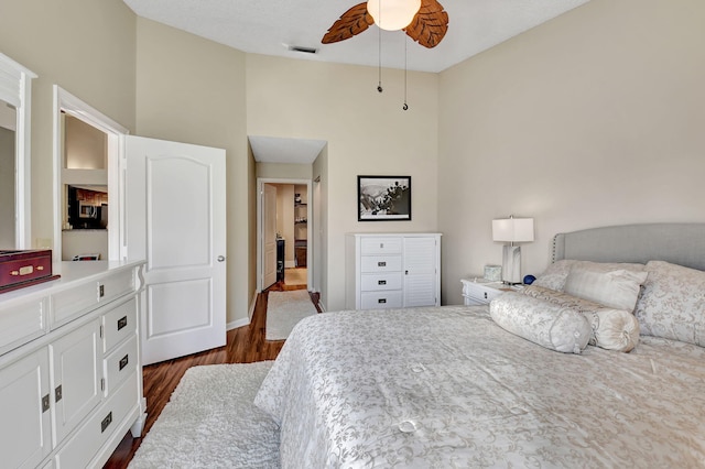 bedroom with ceiling fan and dark hardwood / wood-style flooring