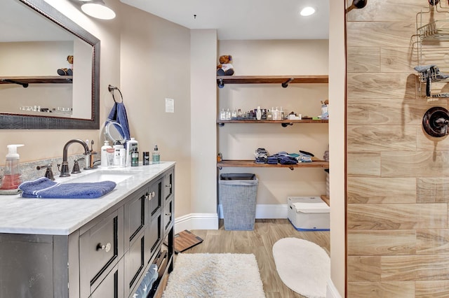 bathroom with vanity, wood-type flooring, and walk in shower