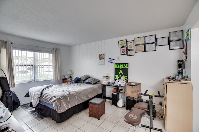 tiled bedroom featuring a textured ceiling