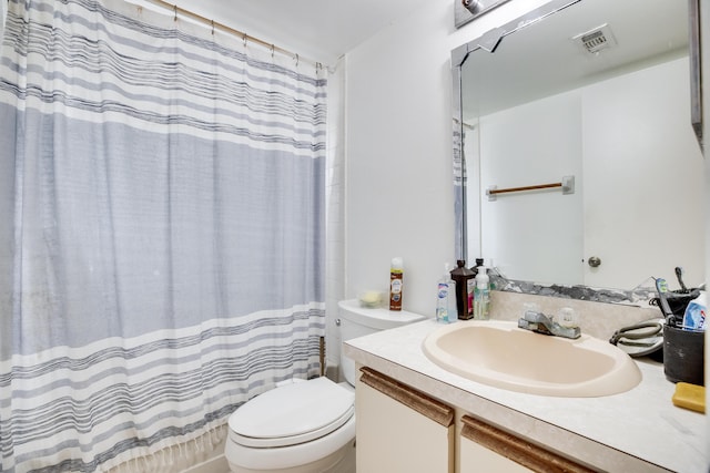 bathroom featuring toilet, a shower with curtain, and vanity