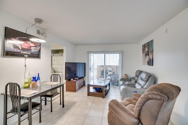 tiled living room featuring stacked washer / drying machine