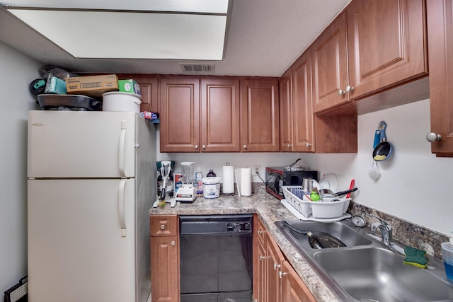 kitchen featuring sink, black dishwasher, white fridge, and tile patterned flooring