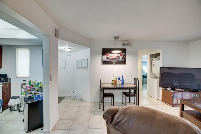 dining area with a textured ceiling and light tile patterned floors