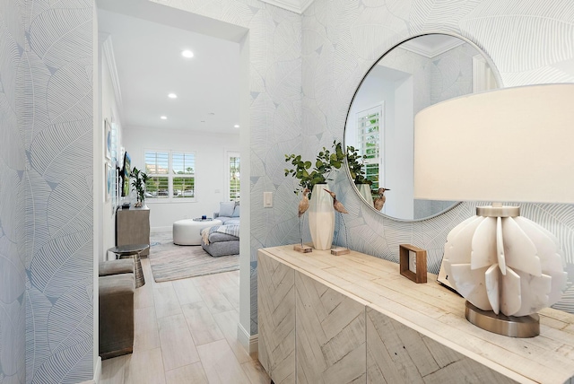 interior space with light hardwood / wood-style flooring and crown molding